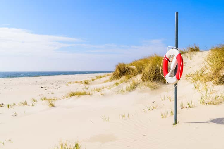 beach with white sand and small sand dunes